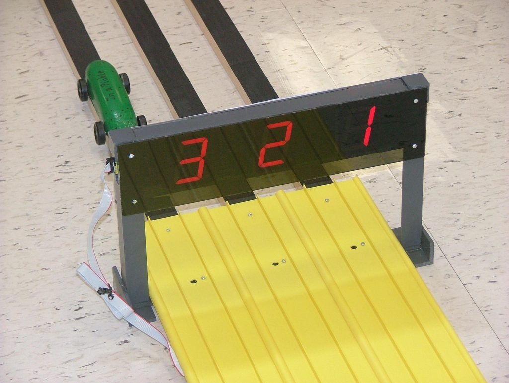 A pinewood derby finish-line timer showing results as cars cross