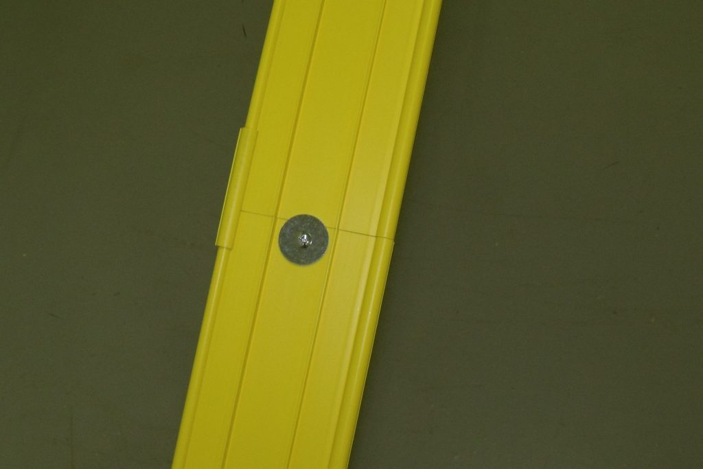 Close-up of the smooth yellow precision-PVC racing surface of a Derby Magic track