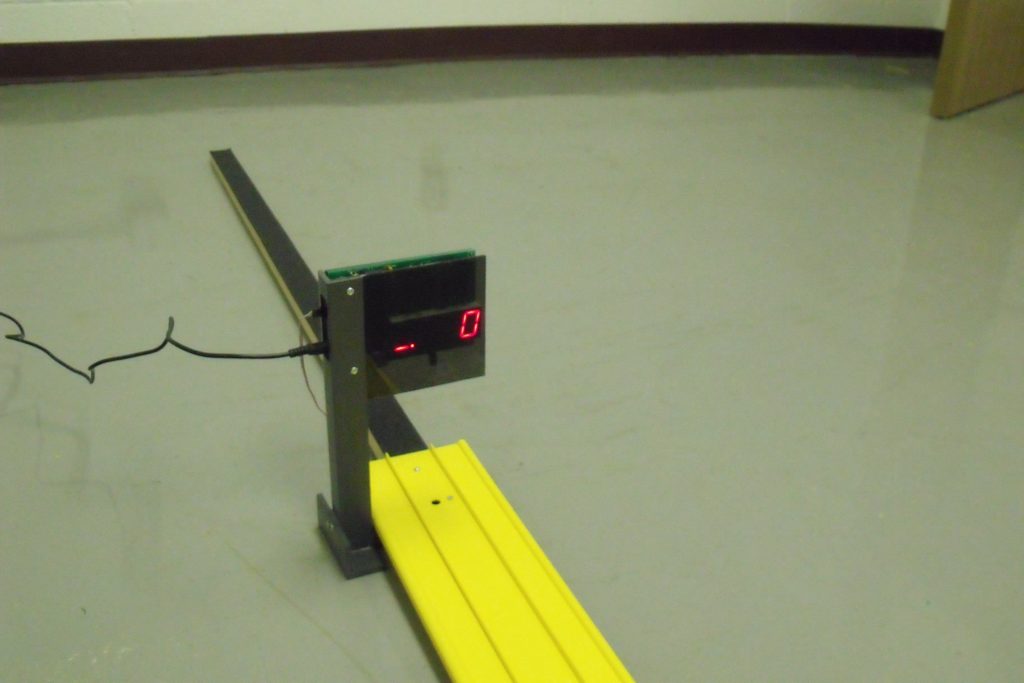 A full-length Derby Magic pinewood derby track with its finish-line timer