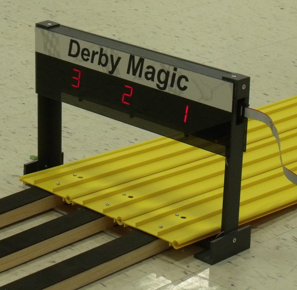 A Derby Magic double-sided finish-line timer counting down over a yellow track