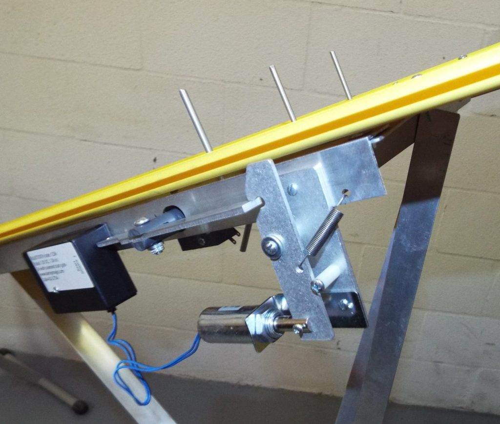 A Derby Magic start gate on a yellow pinewood derby track